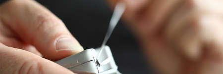Hold dental floss in their hands for cleaning interdental spaceの写真素材