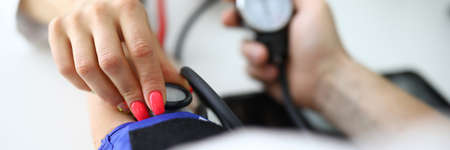 Womans hand holds tonometer and measures patients pressure.の写真素材