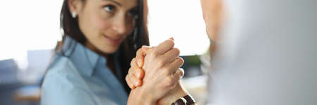 Businesswoman is competing in her arms with man.の写真素材