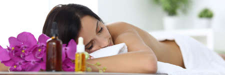 Relaxed woman in spa lies after massage closeupの写真素材