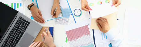 Entrepreneurs sit at table and discuss business performanceの写真素材