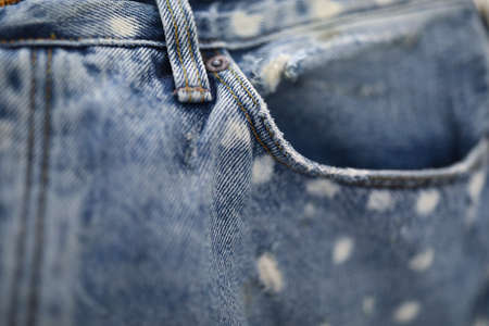 Jeans pocket made of blue frayed fabric closeup.の写真素材