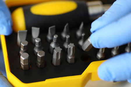 Yellow set with heads for screwdrivers and screwdriver.
