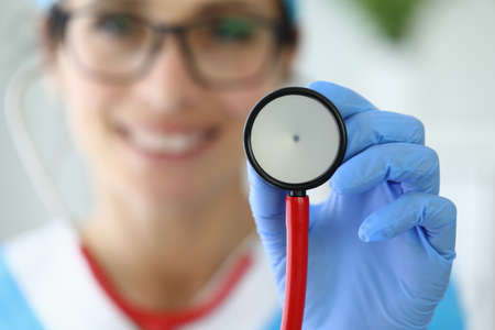 Smiling doctor holding stethoscope in his hand.の写真素材