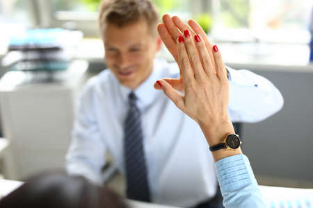 Businessman gives five to colleagues with his hand.の写真素材
