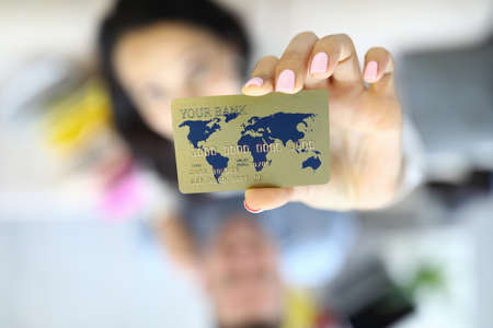 Credit bank card in hands on background of woman.の写真素材