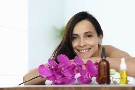 Portrait of smiling brunette woman in spa center.の写真素材