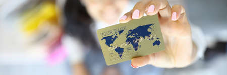 Golden currency bank card in hands of woman with man closeup