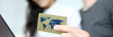 Credit bank card on the background of man and woman.の写真素材