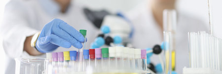 Researcher takes out an empty test tube from tray.の写真素材
