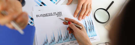 Man and woman in office discuss the companys development plan for 2021.の写真素材