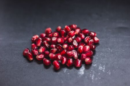 Delicious pomegranate fruit on black background foodの写真素材