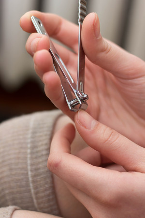Girl cutting her nails With nail cutter fashionの写真素材