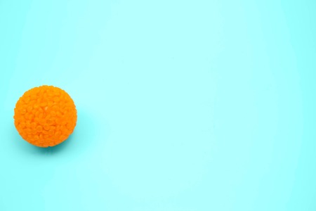 Orange ball on a blue or grey blurred background beautyの写真素材