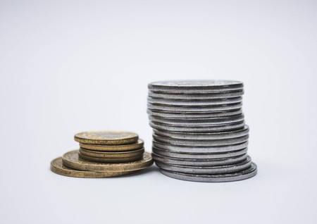 Coin stacks on a white background, pile of coins heap of coins silver gold, copper thai coin, baht currency.の写真素材