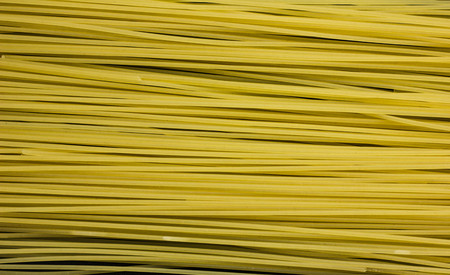 Lots of spaghetti isolated on black background foodの写真素材