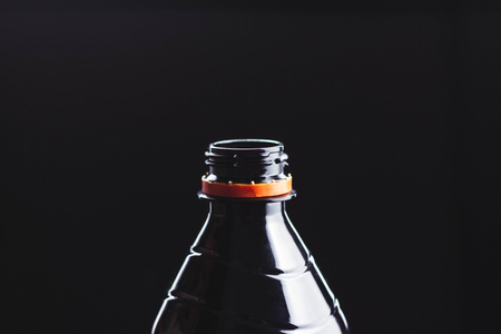 Black bottle on black backgroundの写真素材