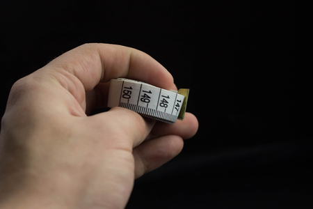 Measuring tape thread on a black background
