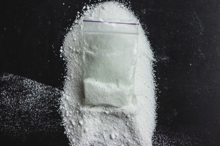 Cocaine drug powder pile on black backgroundの写真素材