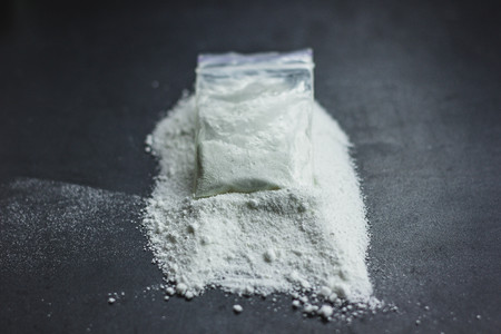 Cocaine drug powder pile on black backgroundの写真素材