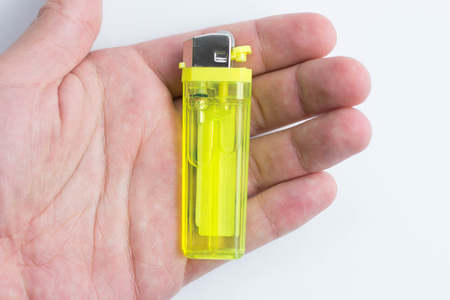 Lighter in a hand isolated on white gasの写真素材
