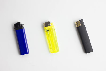 Lighter in a hand isolated on white gasの写真素材