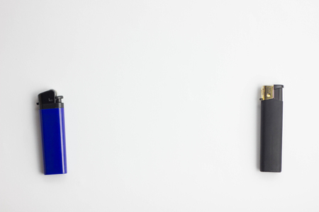Lighter in a hand isolated on white gasの写真素材