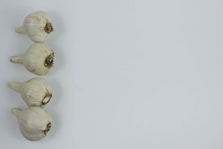 Peeled Garlic (close-up shot) on vintage white backgroundの写真素材