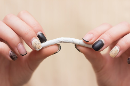 Stop cigarette, man hands breaking the cigarette with clipping path smokeの写真素材