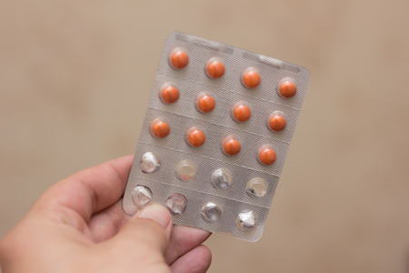 Single red pill in hand plastineの写真素材