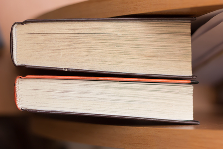 closeup of two books lying on wooden table. shallow dofの写真素材