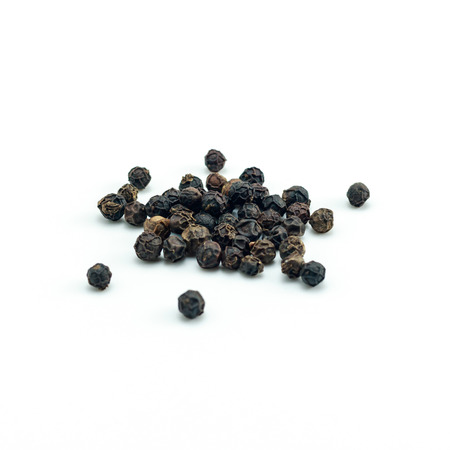Peppercorn with wooden spoon on white background. Composition isolated over the white background.の写真素材