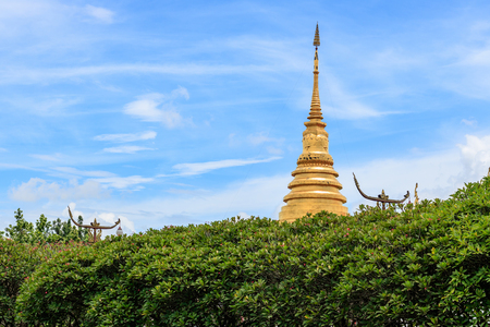 Golden Pagoda with tree and blue sky, Wat Phra Thad Chang Kham, Nan Thailandの写真素材