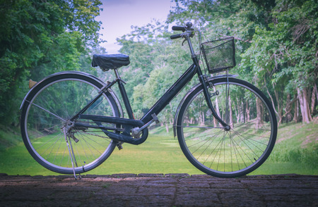 Vintage bicycle parked on the road. Cool tone.の写真素材