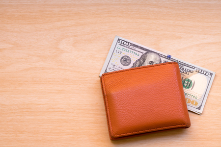 dollar banknotes and wallet on wooden tableの写真素材
