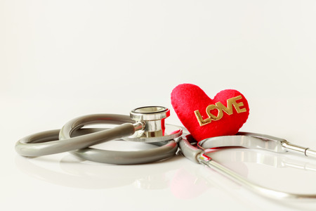 Gray stethoscope with red heart isolated on white background. Medical instruments used to hear sounds within the patient's body.の写真素材