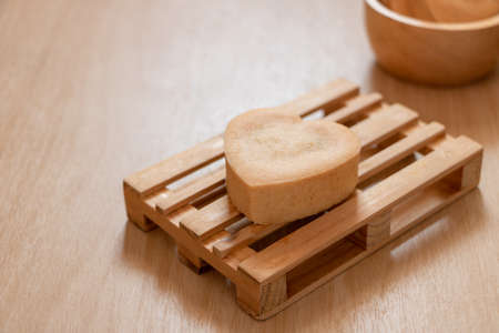 Traditional Chinese pineapple tarts cookies. Heart-shaped pineapple tart cookies are placed on a wooden pallet. Pineapple cake is a sweet traditional Taiwanese pastry containing butter, flour, egg, sugar, and pineapple jam.の写真素材