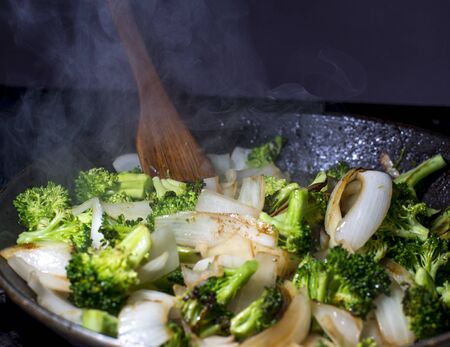 Broccolie and onion stirfry being cooked in panの写真素材