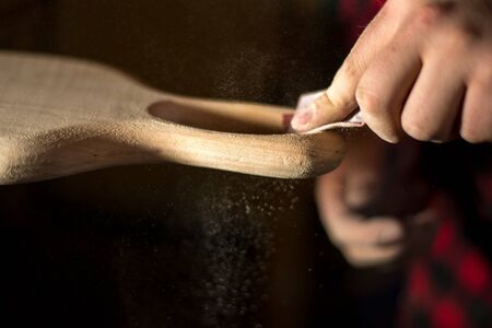 Hands manual sanding a wood handleの写真素材