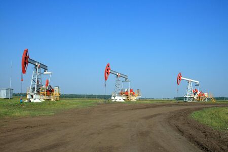 Oil Pump Jack In a field の写真素材