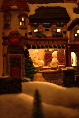 Old ceramic christmas village scene on displayの写真素材