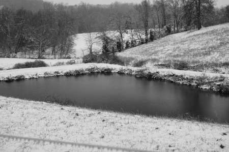 A rural farm scene after a light morning snowの写真素材