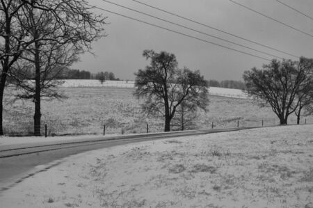 A rural farm scene after a light morning snowの写真素材