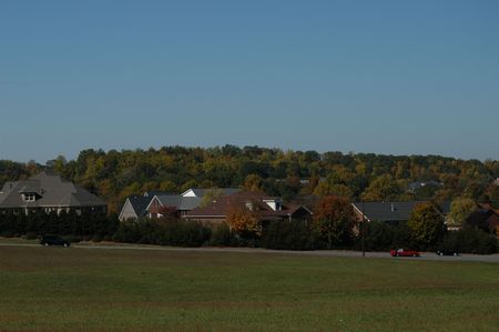 suburban scene with cars and fields in the southの写真素材