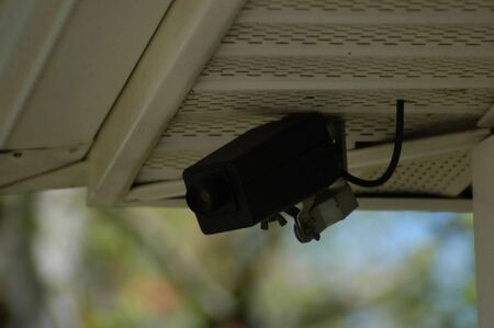 A closeup view of a black security camera