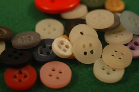A pile of buttons on a field greenの写真素材