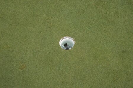 The round hole on a golf course greenの写真素材