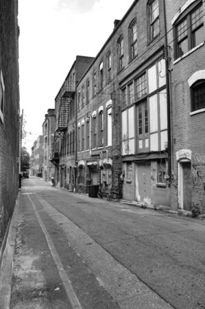 A view of a back alley in a southern town. Shown in black and whiteの写真素材