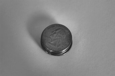 Stack of quarters shown in black and whiteの写真素材