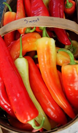 A large basket of peppers at the farmers marketの写真素材